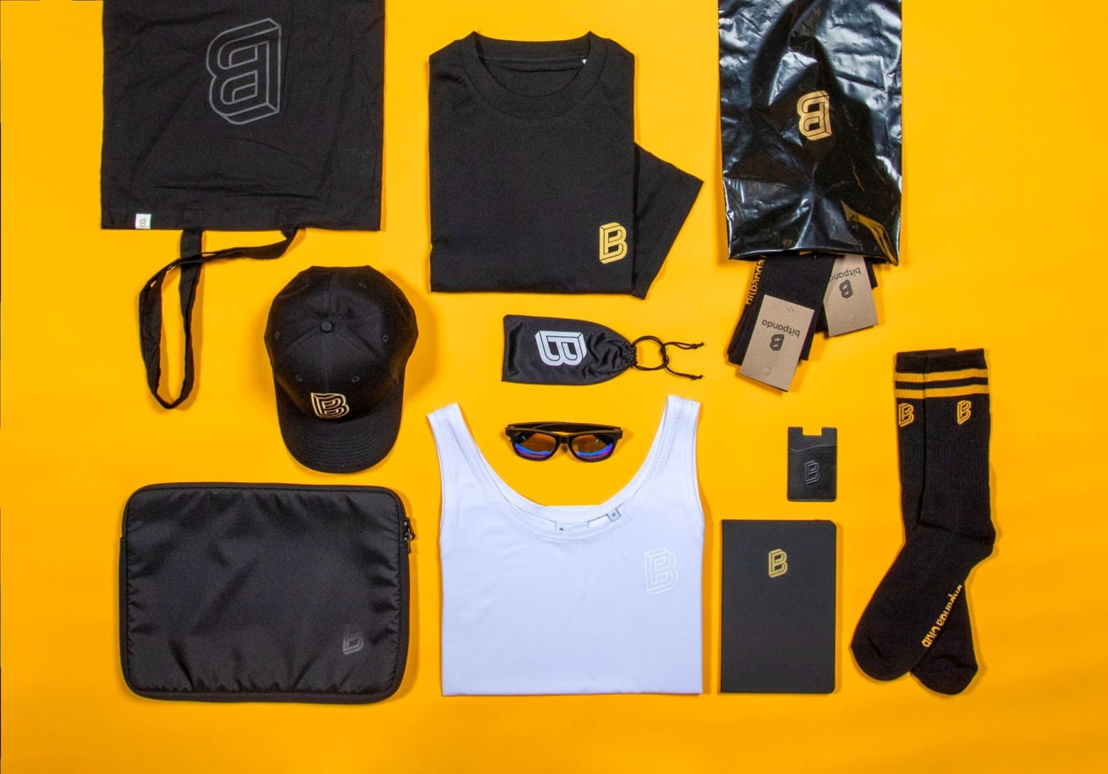 Bitpanda branded merch flatlay on yellow