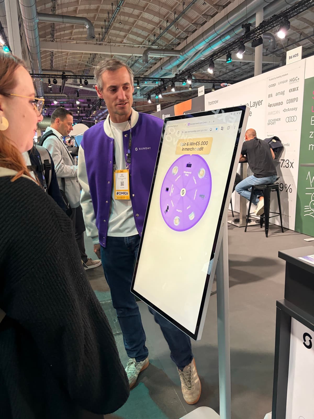 A visitor spinning the Sunday wheel at the OMR Hamburg booth
