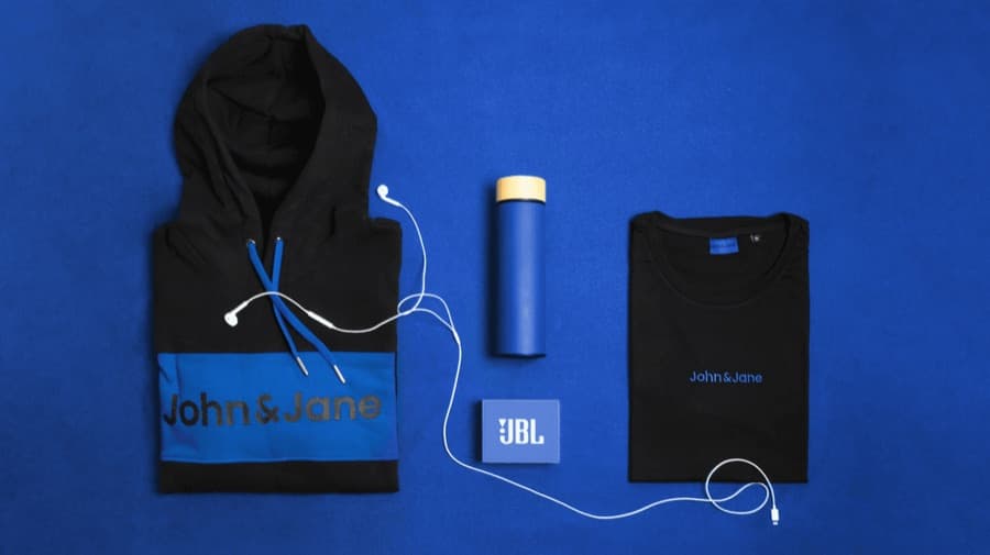 Branded hoodie, bottle and tee flat lay