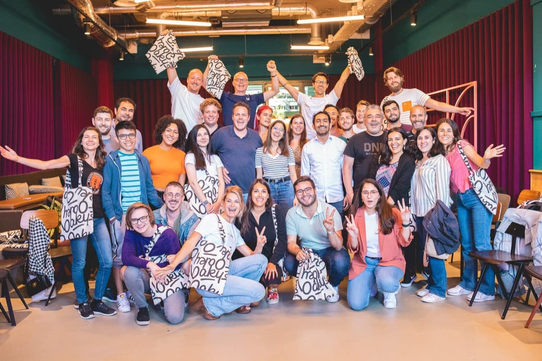 Oaky team group photo holding branded tote bags