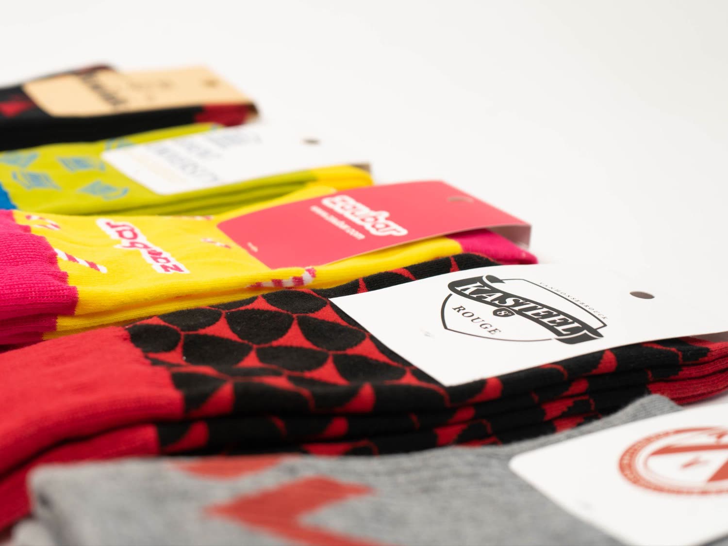 A row of colorful branded socks finished with kraft belly band tags