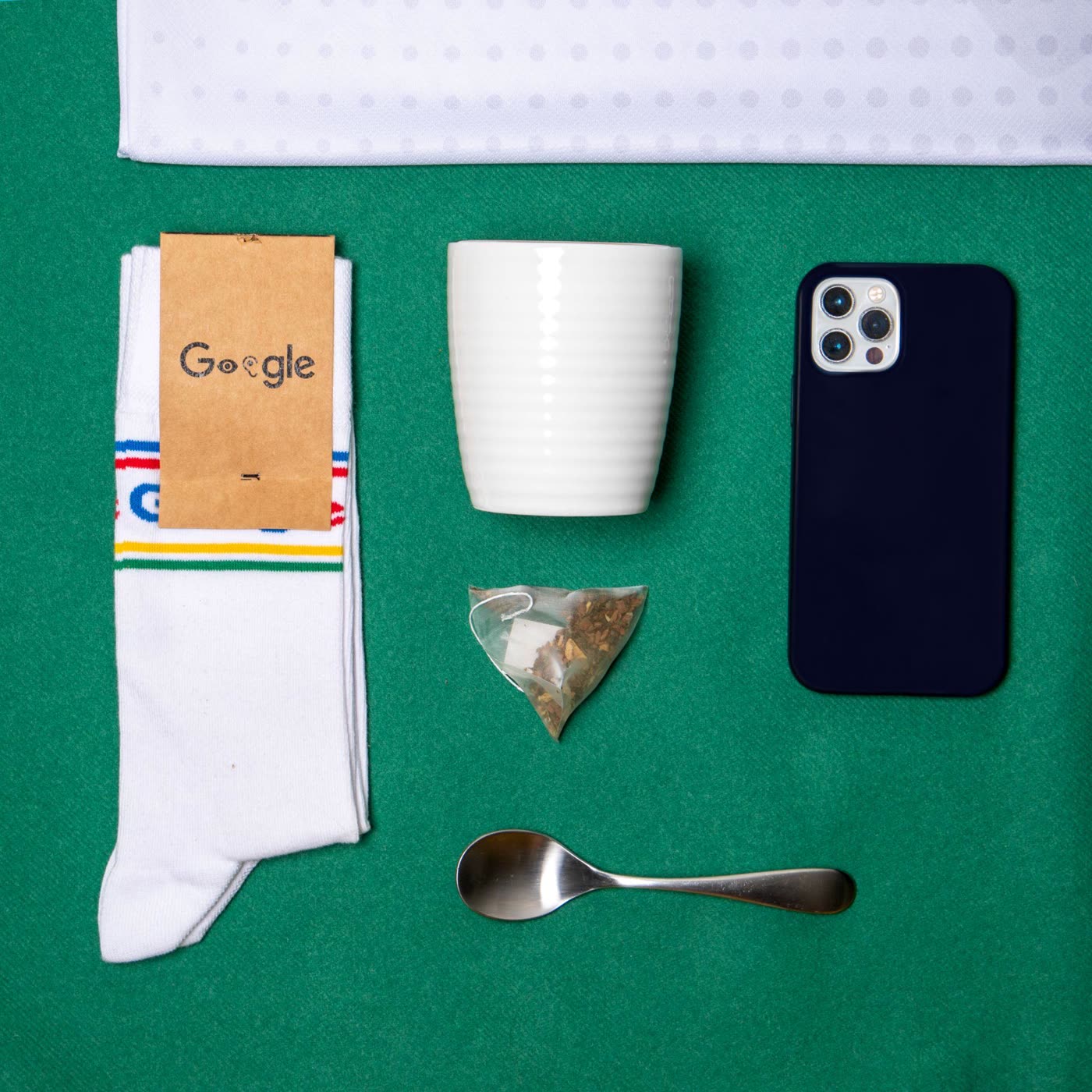 Flat lay of a branded crew sock with everyday desk items