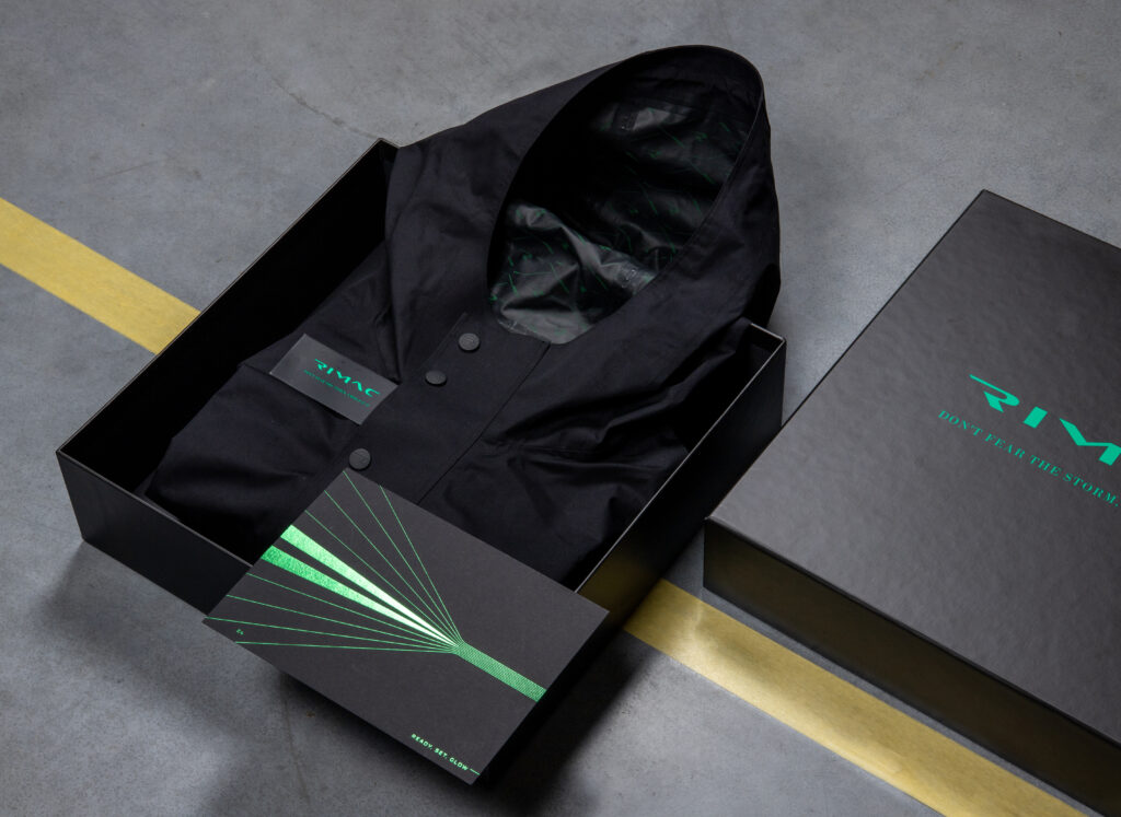 Rimac premium waterproof jacket in branded packaging with green accent design